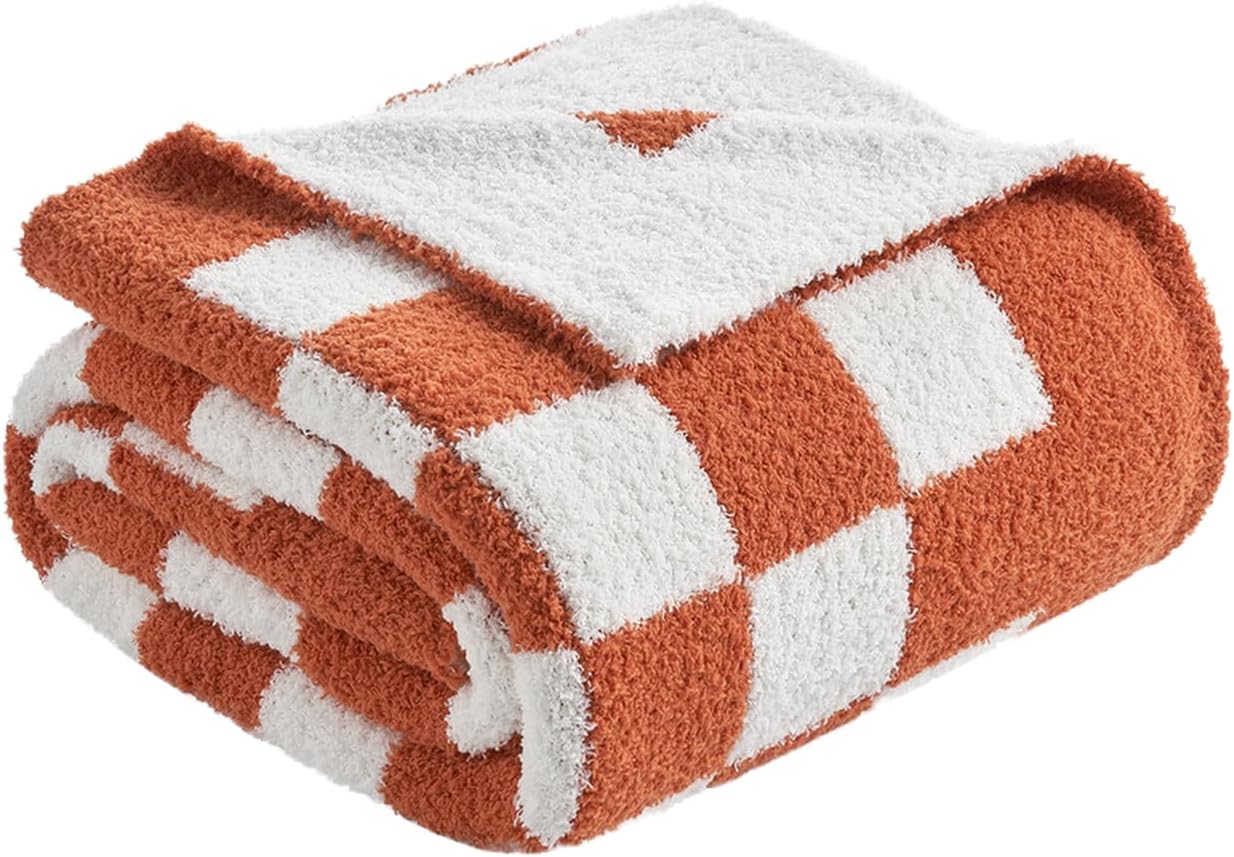 Burnt-orange textured throw blanket for a cozy autumn bedroom